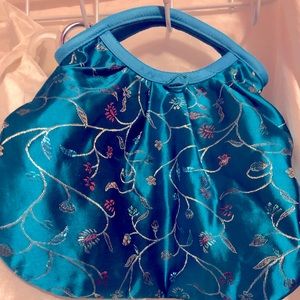 This is a flowery decorated purse.